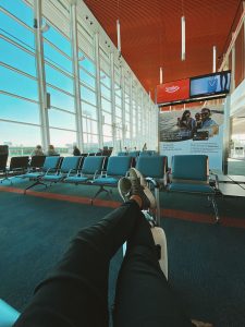 man waiting for flight in airport